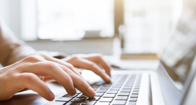 Typing on laptop